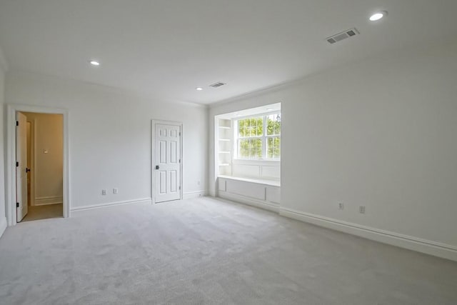 carpeted empty room featuring recessed lighting, visible vents, and baseboards