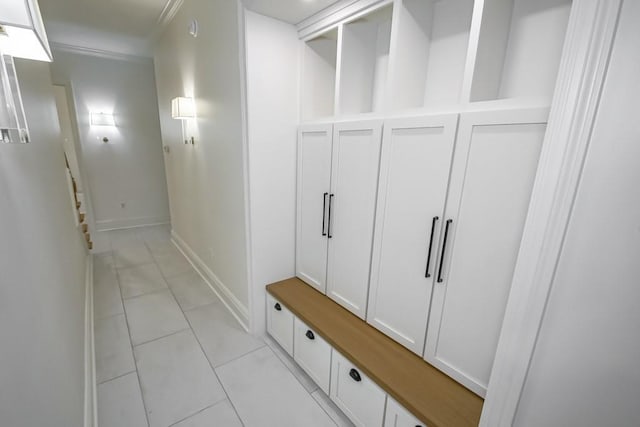 mudroom featuring baseboards, light tile patterned flooring, and crown molding