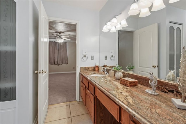 bathroom with ceiling fan, vanity, baseboards, and tile patterned floors