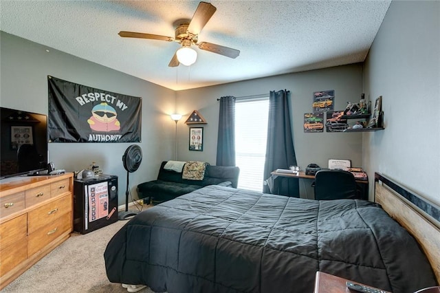 bedroom featuring ceiling fan, a textured ceiling, and light colored carpet