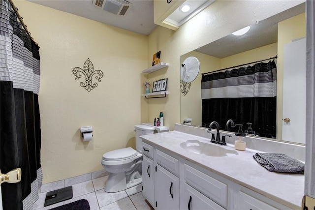 bathroom featuring tile patterned flooring, visible vents, vanity, and toilet