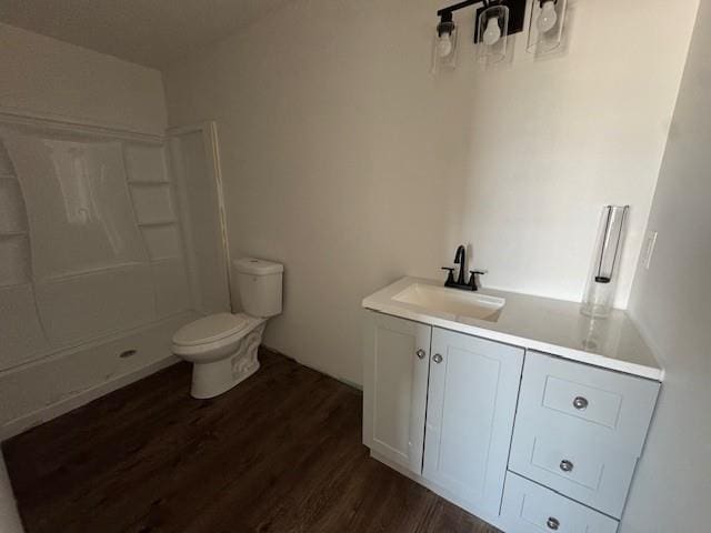 full bath featuring a shower, toilet, wood finished floors, and vanity