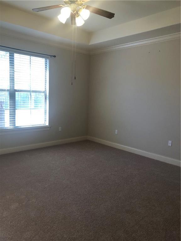40145 Taylors Trl Unit 1002, Slidell, LA 70461 - spare room featuring a ceiling fan, carpet, and baseboards