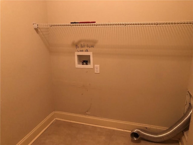 clothes washing area featuring baseboards, washer hookup, and laundry area