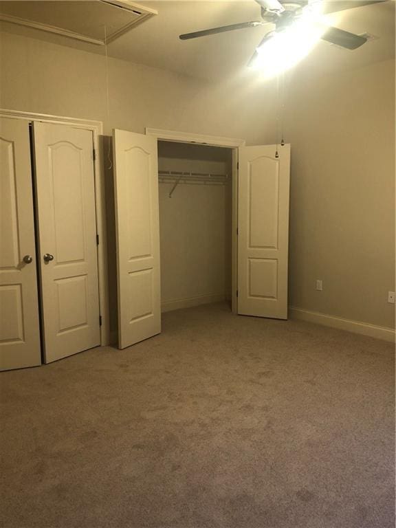 40145 Taylors Trl Unit 1002, Slidell, LA 70461 - unfurnished bedroom featuring attic access, light colored carpet, a ceiling fan, and baseboards
