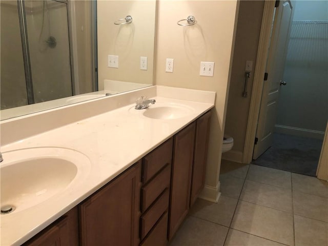 40145 Taylors Trl Unit 1002, Slidell, LA 70461 - bathroom with tile patterned floors, double vanity, toilet, and a stall shower