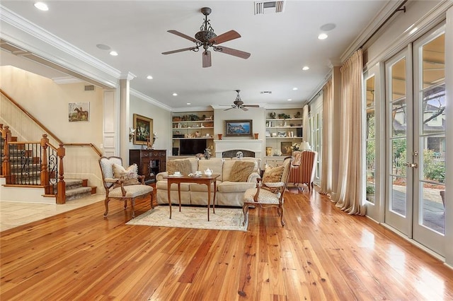 425 Turquoise St, New Orleans, LA 70124 - living area featuring ornamental molding, visible vents, a ceiling fan, built in features, and a fireplace