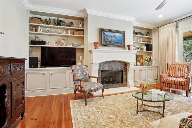 425 Turquoise St, New Orleans, LA 70124 - living room featuring ornamental molding, wood finished floors, built in shelves, and a premium fireplace