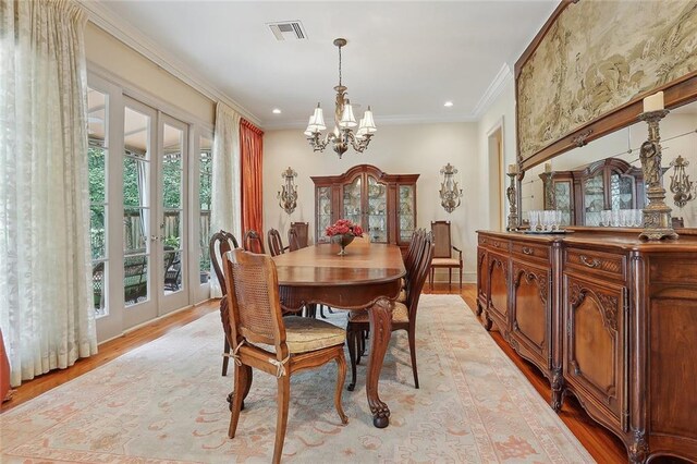 425 Turquoise St, New Orleans, LA 70124 - dining space featuring visible vents, crown molding, recessed lighting, light wood-type flooring, and an inviting chandelier