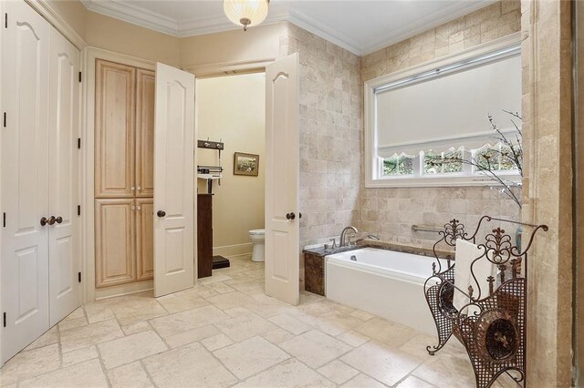 425 Turquoise St, New Orleans, LA 70124 - full bath featuring ornamental molding, toilet, a garden tub, and stone tile flooring