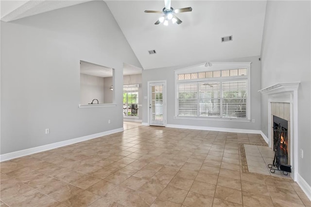 unfurnished living room featuring a ceiling fan, a tile fireplace, visible vents, and baseboards