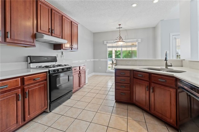 kitchen featuring light tile patterned floors, under cabinet range hood, a sink, range with gas stovetop, and light countertops