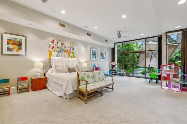 bedroom with a wall of windows, recessed lighting, visible vents, and light carpet