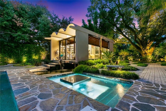 view of pool featuring a patio area and a jacuzzi