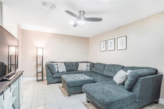 living area with light tile patterned floors, baseboards, visible vents, and a ceiling fan