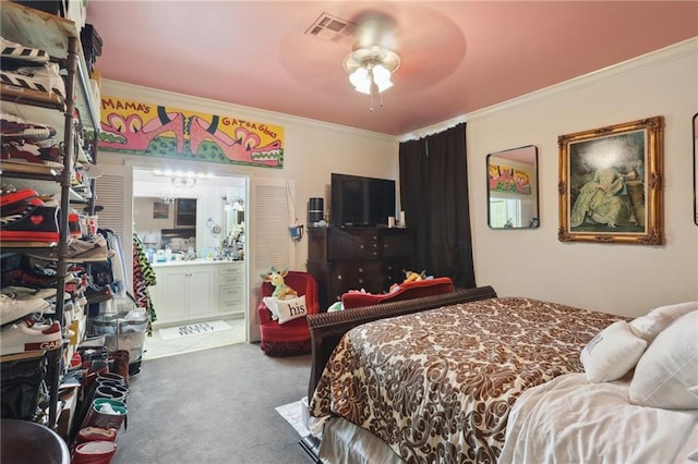 bedroom with visible vents, ensuite bathroom, crown molding, and carpet flooring