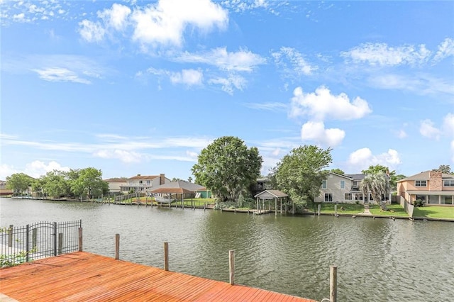 dock area with a residential view and a water view