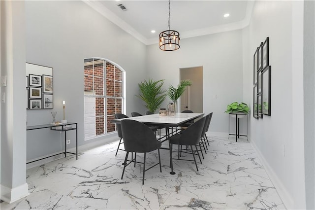 dining area with visible vents, baseboards, ornamental molding, a high ceiling, and marble finish floor