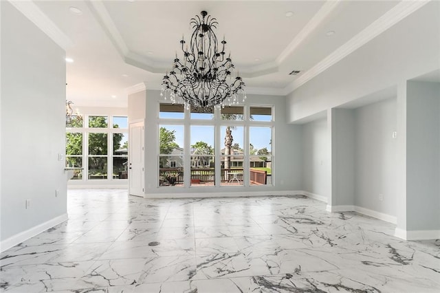 interior space with baseboards, a tray ceiling, ornamental molding, a notable chandelier, and marble finish floor