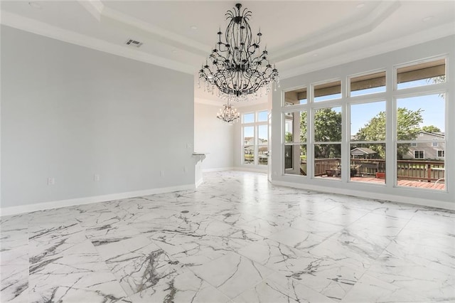 unfurnished room with baseboards, visible vents, a tray ceiling, ornamental molding, and a chandelier