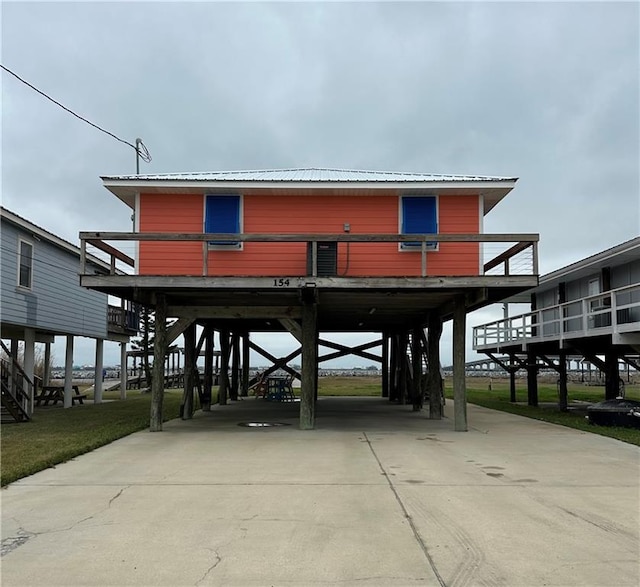 view of community with a carport and concrete driveway