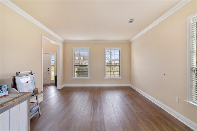 interior space featuring dark wood-style floors, baseboards, visible vents, and ornamental molding