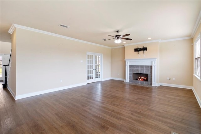 unfurnished living room featuring a fireplace, dark wood finished floors, visible vents, and crown molding