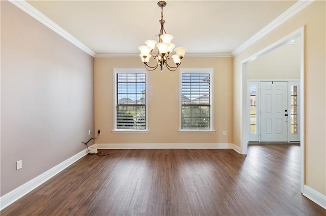 unfurnished dining area featuring dark wood-style floors, ornamental molding, and baseboards