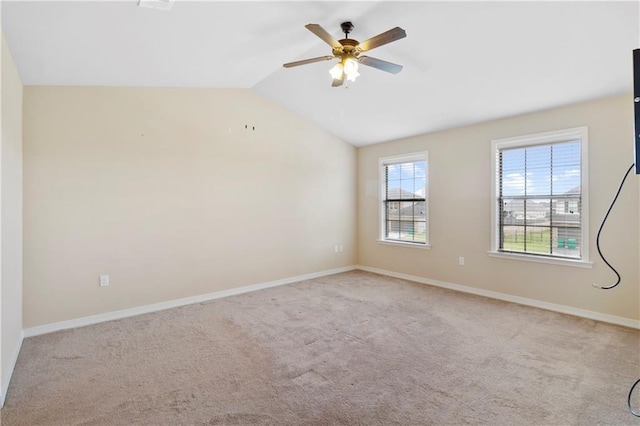 unfurnished room featuring baseboards, vaulted ceiling, a ceiling fan, and light colored carpet