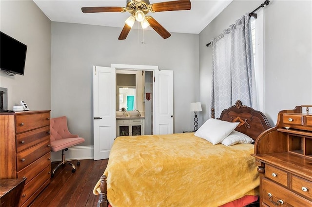 bedroom with a ceiling fan, baseboards, and dark wood-type flooring