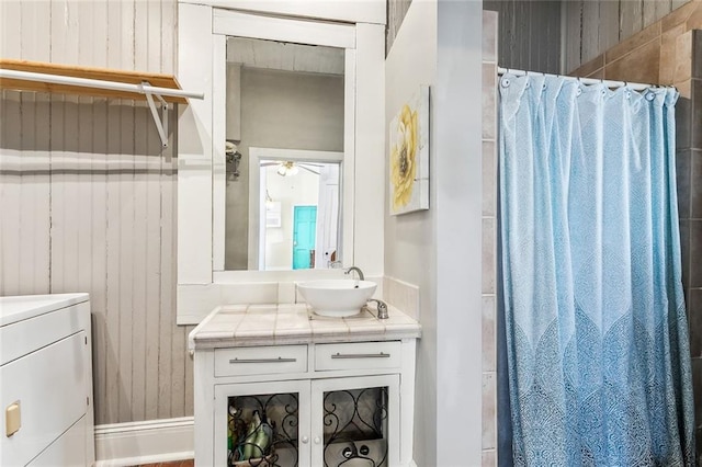 bathroom featuring a shower stall, washer / clothes dryer, and vanity