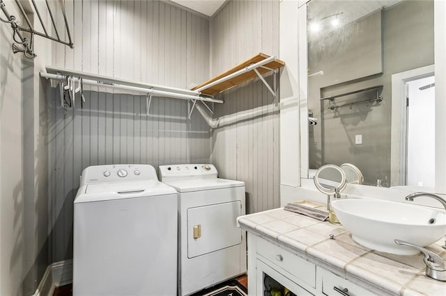 laundry room with a sink, laundry area, and washing machine and dryer