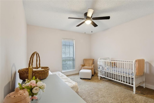 bedroom featuring carpet, a textured ceiling, and a ceiling fan