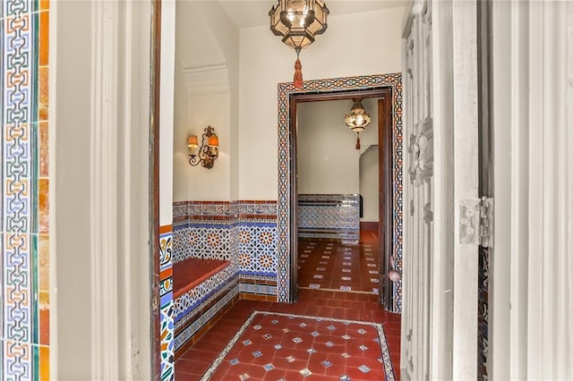 hall with tile patterned floors