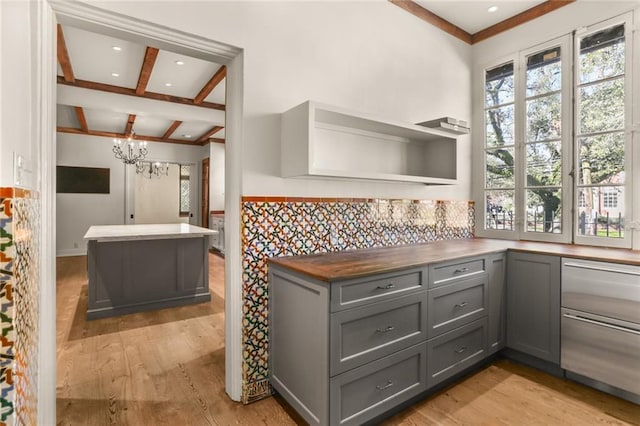 kitchen featuring open shelves, light wood finished floors, gray cabinets, and a healthy amount of sunlight