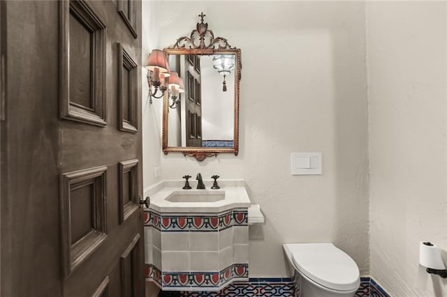 half bath featuring a sink and toilet