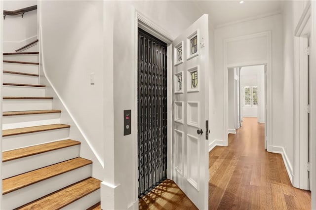 stairs with baseboards and wood finished floors