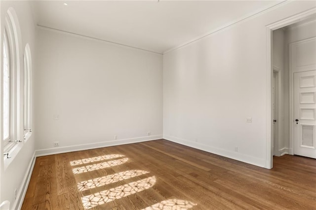 empty room with baseboards and wood finished floors