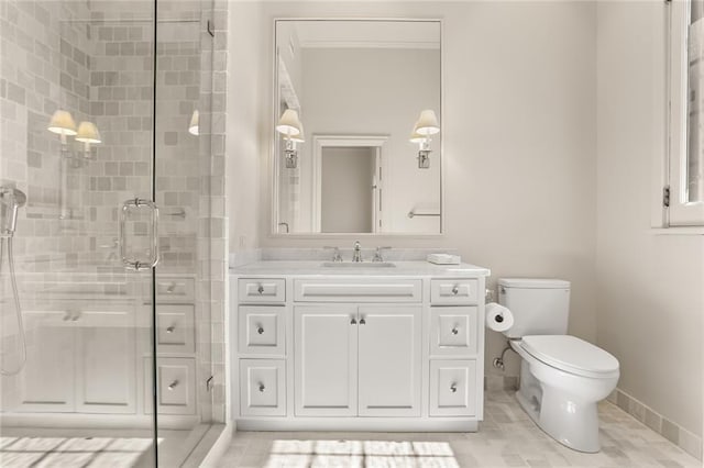 bathroom featuring a stall shower, baseboards, vanity, and toilet