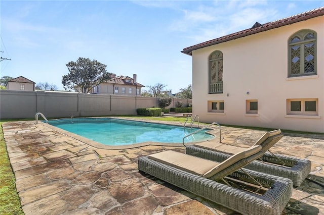 view of swimming pool with a patio area, a fenced backyard, and a fenced in pool