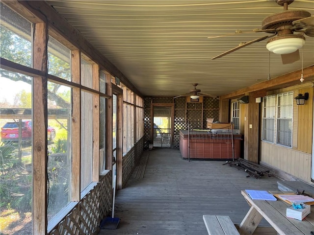 unfurnished sunroom with a ceiling fan