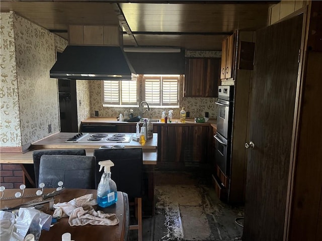 kitchen featuring exhaust hood, gas stovetop, light countertops, dark brown cabinets, and decorative backsplash