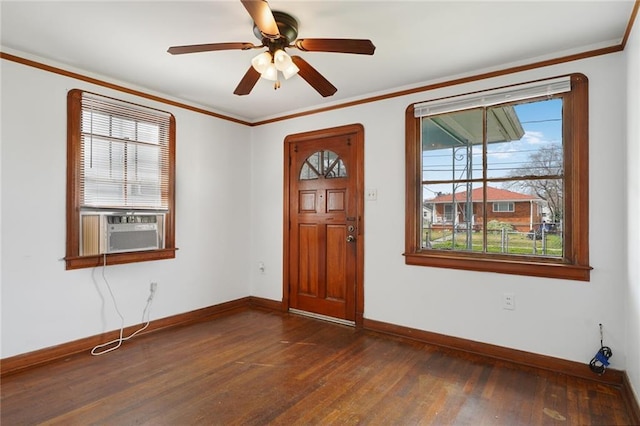 foyer entrance featuring crown molding, dark wood finished floors, a ceiling fan, cooling unit, and baseboards