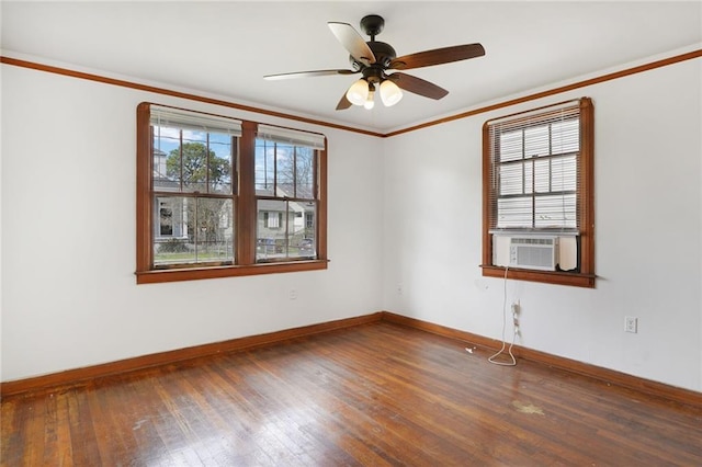 empty room featuring baseboards, a ceiling fan, ornamental molding, hardwood / wood-style floors, and cooling unit