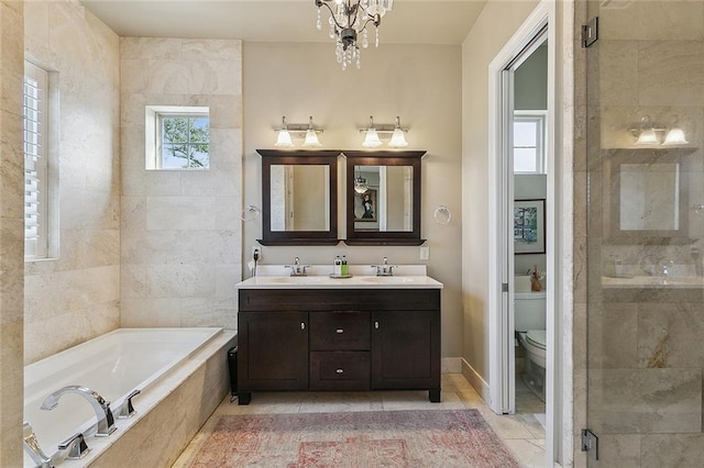 full bath featuring a garden tub, toilet, a notable chandelier, double vanity, and a stall shower