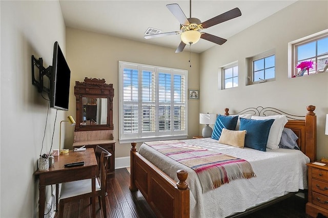 bedroom with a ceiling fan, visible vents, dark wood finished floors, and baseboards