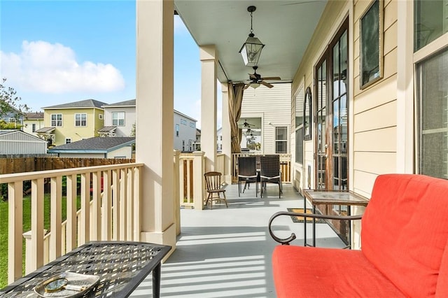 balcony with a residential view and a ceiling fan