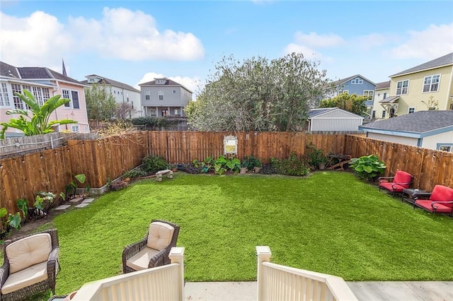 view of yard featuring a fenced backyard and a residential view