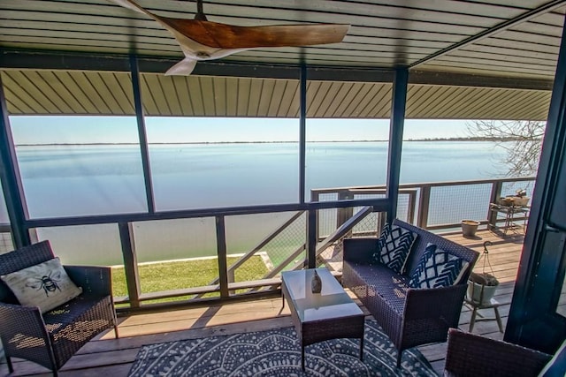 sunroom featuring a water view