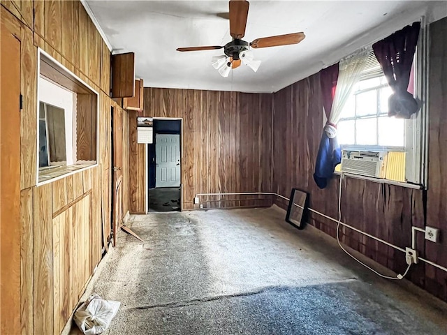 empty room with wood walls, cooling unit, and a ceiling fan